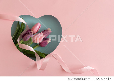 Tulip Bouquet in Heart Cutout. Romantic Valentines Day Flatlay with Ribbon on Pink Background Tulip Bouquet in Heart Cutout. Romantic Valentines Day Flatlay with Ribbon on Pink Background 135925616