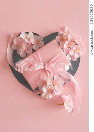Blue Heart Cutout. Romantic Valentines Day Flatlay with Gift Box and Cherry Blossom on Pink Background 135925620