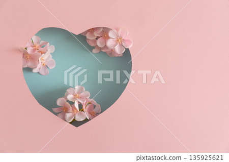 Blue Heart Cutout. Romantic Valentines Day Flatlay with Cherry Blossom on Pink Background Blue Heart Cutout. Romantic Valentines Day Flatlay with Cherry Blossom on Pink Background 135925621