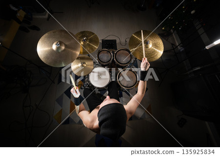 Drummer playing electronic drum kit performing music 135925834