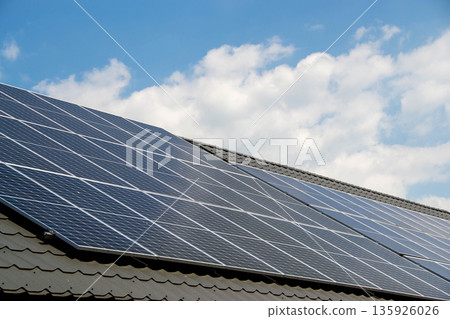 House roof with photovoltaic modules. Historic farm house with modern solar panels on roof and wall High quality photo House roof with photovoltaic modules. Historic farm house with modern solar panels on roof and wall High quality photo 135926026