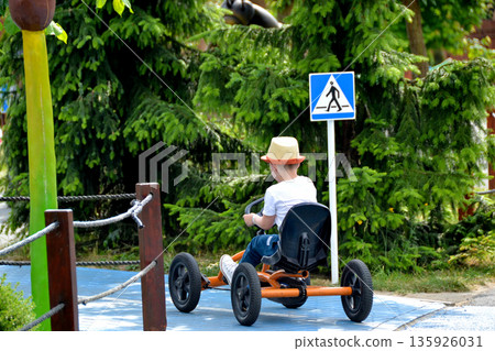boy driving quad bike, four wheel cycle car, spring brightly morning, sunny day. High quality photo boy driving quad bike, four wheel cycle car, spring brightly morning, sunny day. High quality photo 135926031