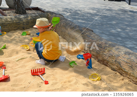 Boy and girl playing on the beach on summer holidays. Children building a sandcastle at the sea. High quality photo Boy and girl playing on the beach on summer holidays. Children building a sandcastle at the sea. High quality photo 135926065