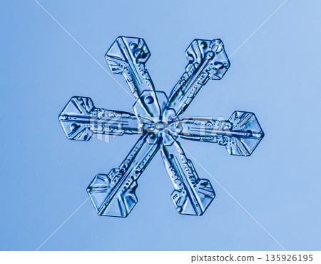 Natural snowflake crystal in blue background 135926195