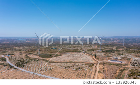 Wind green energy. Wind energy generators stand tall in a vast landscape, showcasing ecological energy solutions for a sustainable future in green electricity 135926343