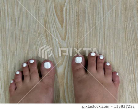 White Pedicure on Wooden Floor 135927252