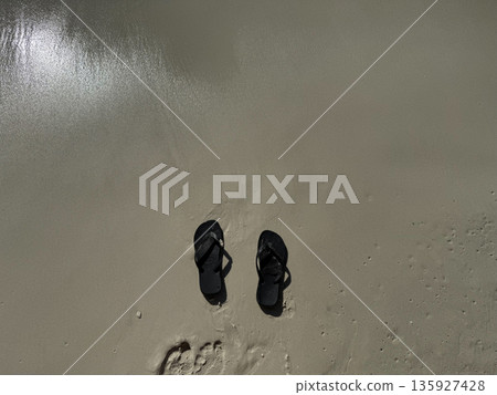 Flip Flops on Wet Sand Beach 135927428