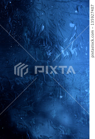 Vertical stock photo of patterns left by severe frost on a smooth surface. Abstract Frozen Blue Textured Background Vertical stock photo of patterns left by severe frost on a smooth surface. Abstract Frozen Blue Textured Background 135927487