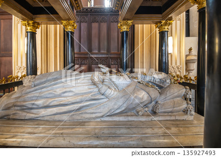 Elizabeth I is at rest in her tomb in Westminster Abbey. People visit the site to view the ornate details of her memorial located in London, United Kingdom. The tomb shows a detailed sculpture. 135927493