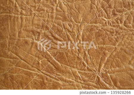 Brown textured leather background. Natural texture close-up. Useful as background for design-works. Brown textured leather background. Natural texture close-up. Useful as background for design-works. 135928266