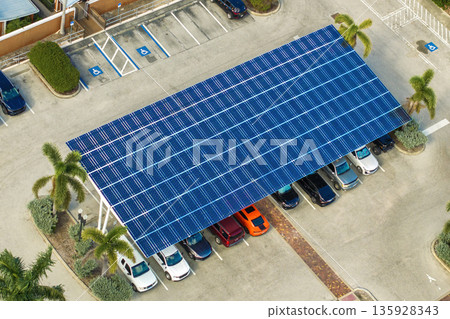 Sustainable power production integrated in urban infrastructure. Photovoltaic solar panels over car parking place for generation of renewable energy. 135928343