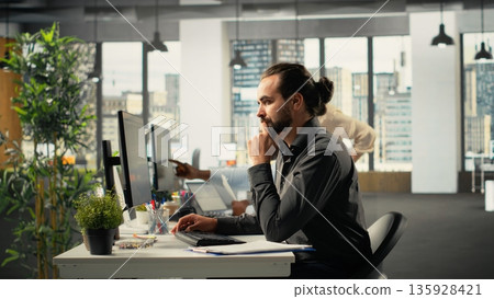 Multiethnic team of employees exchanging ideas during business meeting. Professional staff examining financial data, targets and business intel to align targets for company progress. Multiethnic team of employees exchanging ideas during business meeting. Professional staff examining financial data, targets and business intel to align targets for company progress. 135928421