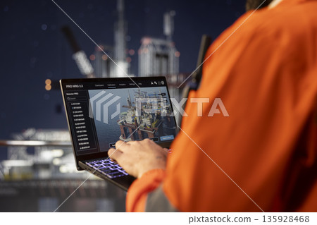 Close up of offshore platform technicians checking equipment status indicators on laptop system dashboard. Workers verifying hydraulic pressure levels on notebook digital monitoring panel Close up of offshore platform technicians checking equipment status indicators on laptop system dashboard. Workers verifying hydraulic pressure levels on notebook digital monitoring panel 135928468