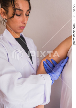 Doctor performing breast examination for cancer detection Doctor performing breast examination for cancer detection 135928722