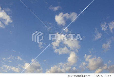 It's a late afternoon sky with fluffy clouds. It's a late afternoon sky with fluffy clouds. 135929256
