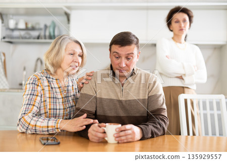Family quarrel, old woman calming man Family quarrel, old woman calming man 135929557