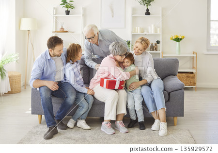Family Surprising Grandmother With Birthday Or Anniversary Celebration 135929572