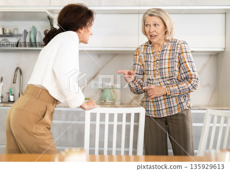 Domestic quarrel - elderly mother quarrels with her adult daughter and starts screaming Domestic quarrel - elderly mother quarrels with her adult daughter and starts screaming 135929613