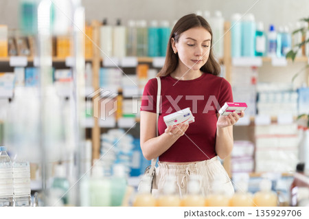 woman chooses paracetamol at the pharmacy woman chooses paracetamol at the pharmacy 135929706