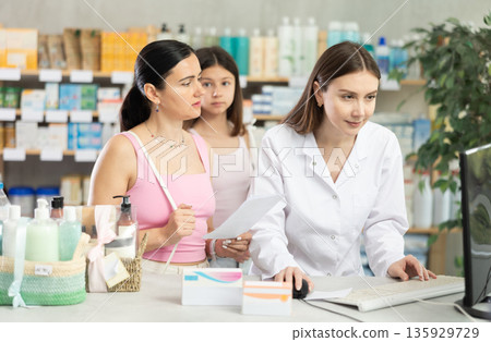 Pharmacist looking for prescription for mother and daughter buyers Pharmacist looking for prescription for mother and daughter buyers 135929729