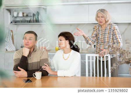 Family quarrel, adult woman calming man 135929802