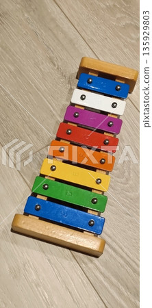 Children's metallophone on laminate, on wooden floor Children's metallophone on laminate, on wooden floor 135929803