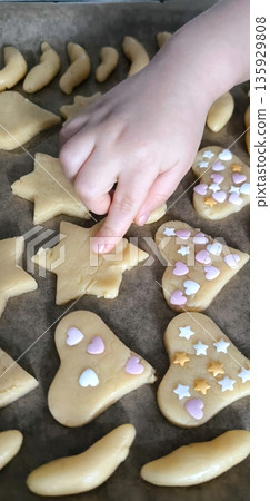 top view of children cutting gingerbread cookies from metal molds top view of children cutting gingerbread cookies from metal molds 135929808