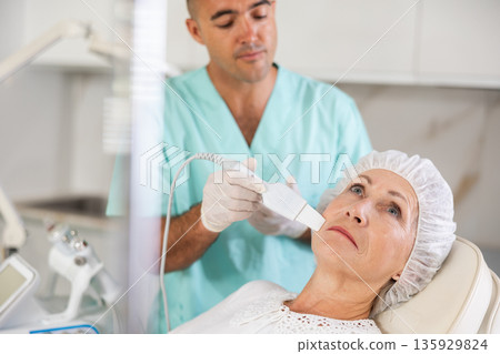 Using skin scrubber 135929824