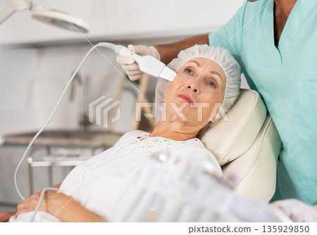 doctor uses skin scrubber doctor uses skin scrubber 135929850