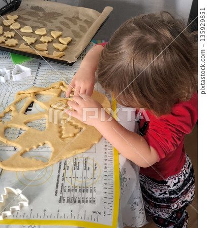 top view of children cutting gingerbread cookies from metal molds top view of children cutting gingerbread cookies from metal molds 135929851