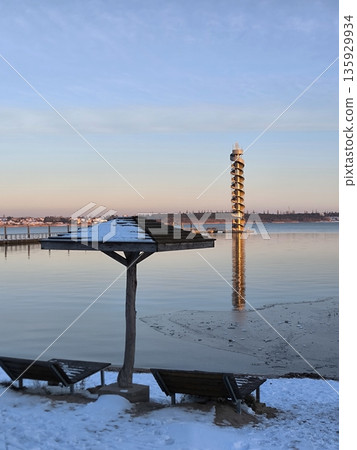 A modern observation tower over a frozen lake on a winter evening, Bitterfeld, Germany 135929934