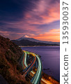 Sunrise sky and car light trails on Mount Fuji seen from Satta Pass 135930037