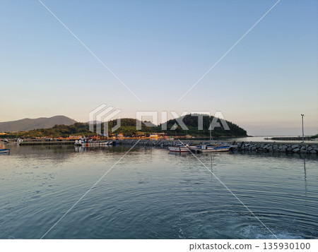 This is a view of an island village at sunset. This is a view of an island village at sunset. 135930100