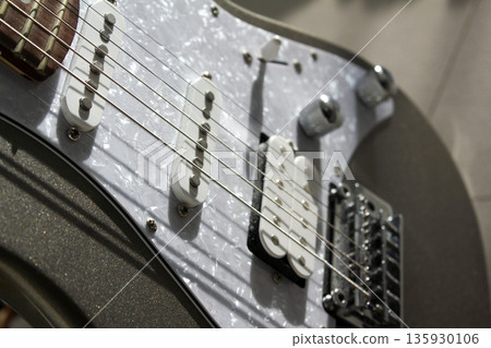 This is a close-up of the electric guitar strings. This is a close-up of the electric guitar strings. 135930106
