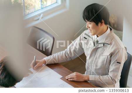 Two men looking at documents and having a meeting Two men looking at documents and having a meeting 135930613