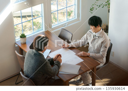 Two men looking at documents and having a meeting Two men looking at documents and having a meeting 135930614