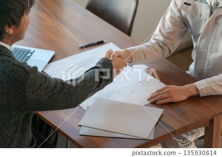 Two men looking at documents and having a meeting Two men looking at documents and having a meeting 135930814