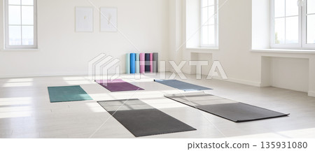 Sunlit yoga studio interior with mats on floor and bright windows, minimalist Sunlit yoga studio interior with mats on floor and bright windows, minimalist 135931080