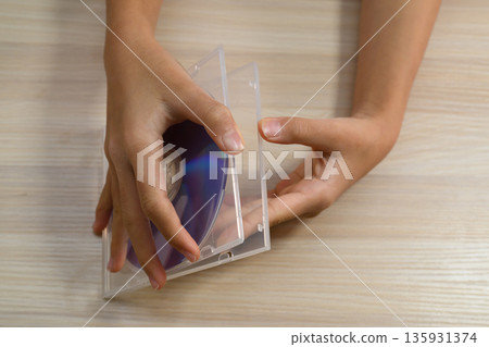 俯拍鏡頭,雙手打開CD盒 俯拍鏡頭,雙手打開CD盒 135931374