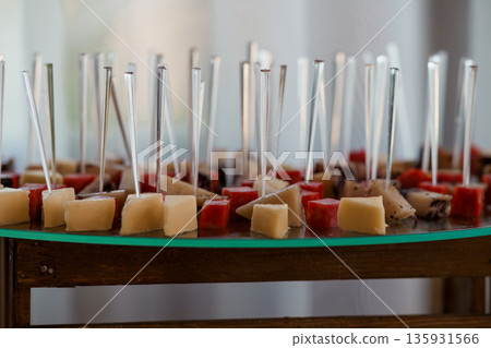Elegant Cheese and Charcuterie Skewers Displayed on Glass Tray at Event or Gathering Elegant Cheese and Charcuterie Skewers Displayed on Glass Tray at Event or Gathering 135931566