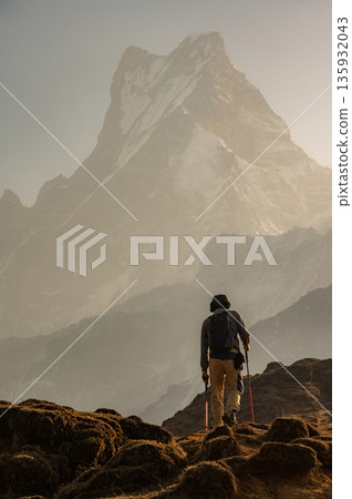Rear view of tourist walking to Mardi Himal base camp with beautiful view of Mt.Machapuchare in the background. Mardi Himal Trek is one of the newly popular trekking route in the Nepal. 135932043
