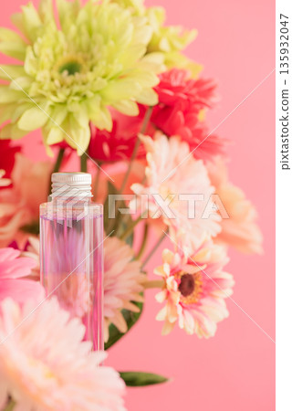 Gerbera and cosmetic bottles arranged on a pink background Gerbera and cosmetic bottles arranged on a pink background 135932047
