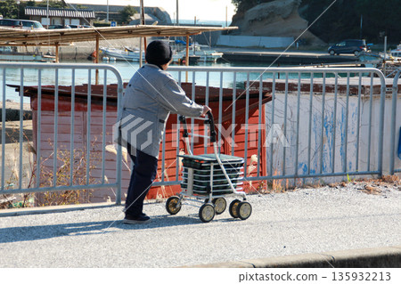 Old woman and silver car in fishing village Old woman and silver car in fishing village 135932213