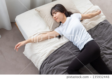 Women stretching in bed 135932448