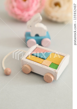 A small baby bottle, a rolling rabbit, and building blocks 135932487