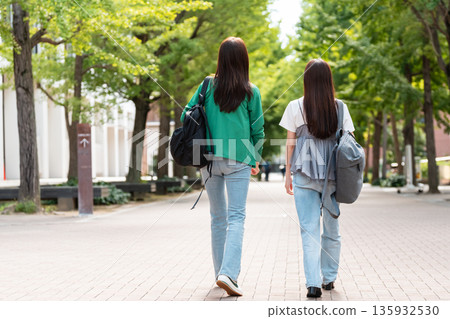 Female college student walking on university campus Female college student walking on university campus 135932530