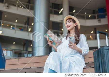 A woman planning a trip 135932594