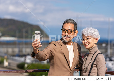 Senior couple traveling. Photo courtesy of Ito Marine Town Roadside Station. 135932711