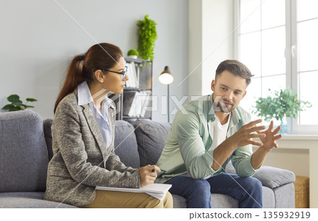 Man at psychotherapy session with psychologist and counselor in office, therapy for patient Man at psychotherapy session with psychologist and counselor in office, therapy for patient 135932919