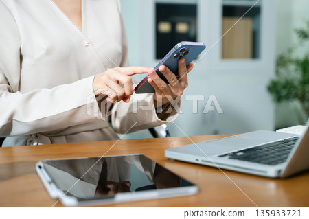 Businesswoman hand working digital marketing media in virtual screen with mobile phone and modern compute Businesswoman hand working digital marketing media in virtual screen with mobile phone and modern compute 135933721